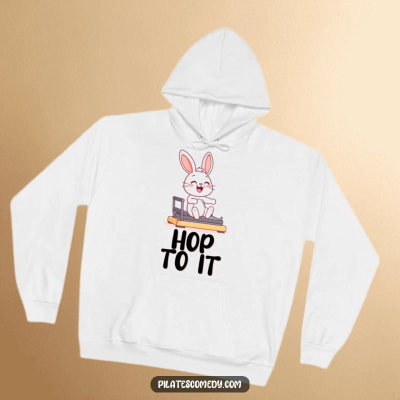 Funny joyful bunny character smiling, in a graceful pose on a Pilates reformer machine, on a warm hoodie.